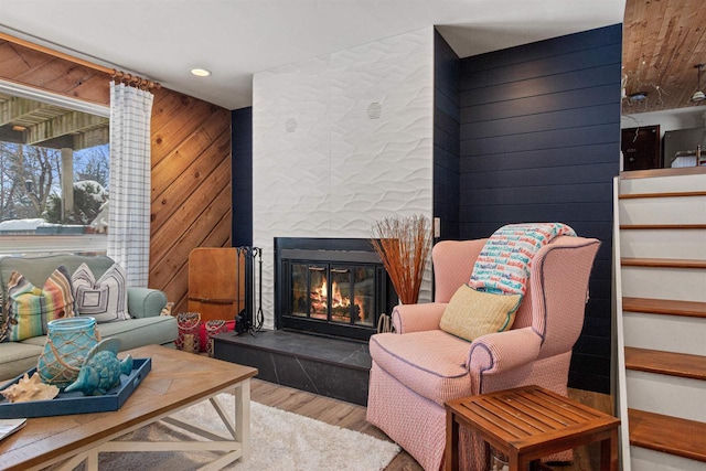 865 Richmond Way, Nekoosa, WI 54457 - living area featuring wooden walls, wood finished floors, a fireplace, stairs, and recessed lighting