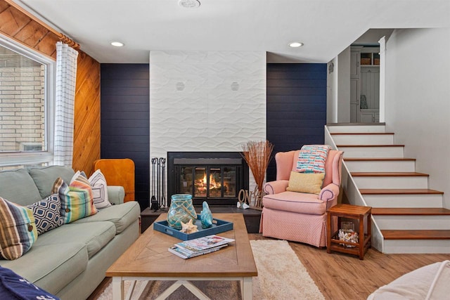 865 Richmond Way, Nekoosa, WI 54457 - living area with wood finished floors, stairway, a fireplace with flush hearth, and recessed lighting