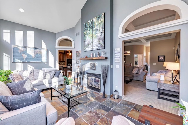 living room featuring high vaulted ceiling