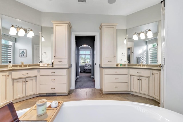 bathroom with tile patterned floors and vanity