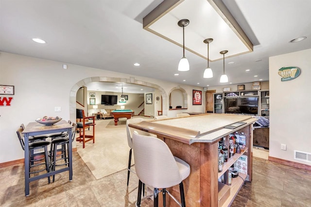 kitchen with pendant lighting, a kitchen breakfast bar, and billiards