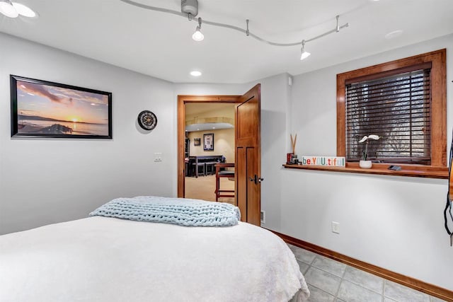 bedroom featuring track lighting