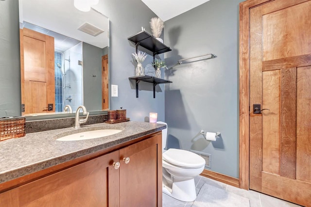 bathroom featuring tile patterned floors, toilet, a shower with shower door, and vanity