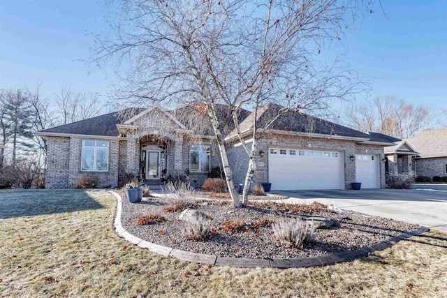 ranch-style house featuring a garage and a front lawn