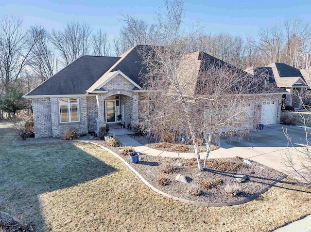 view of front of property with a garage and a front lawn