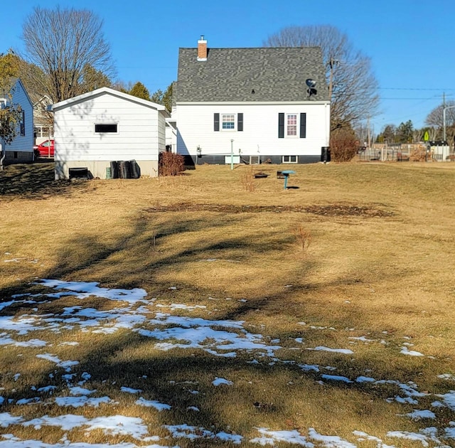 snow covered property with a yard