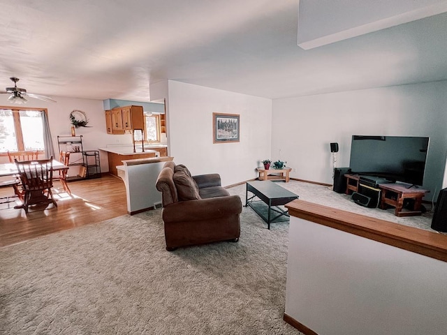 living room featuring light colored carpet and ceiling fan