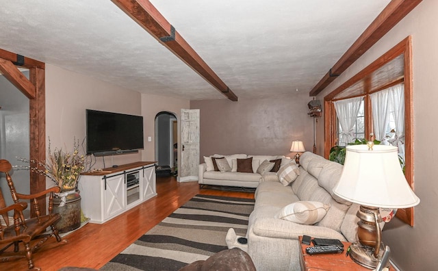 living room featuring hardwood / wood-style flooring and beam ceiling