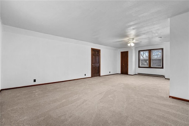 carpeted spare room featuring a baseboard radiator, a textured ceiling, and ceiling fan