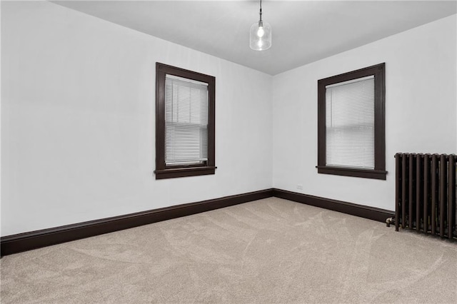 carpeted empty room with radiator