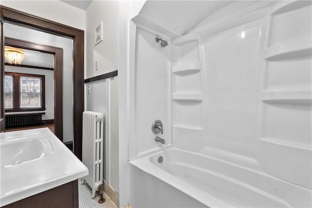 bathroom featuring shower / bathtub combination, vanity, and radiator