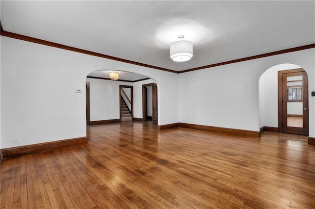 unfurnished room featuring ornamental molding and hardwood / wood-style floors