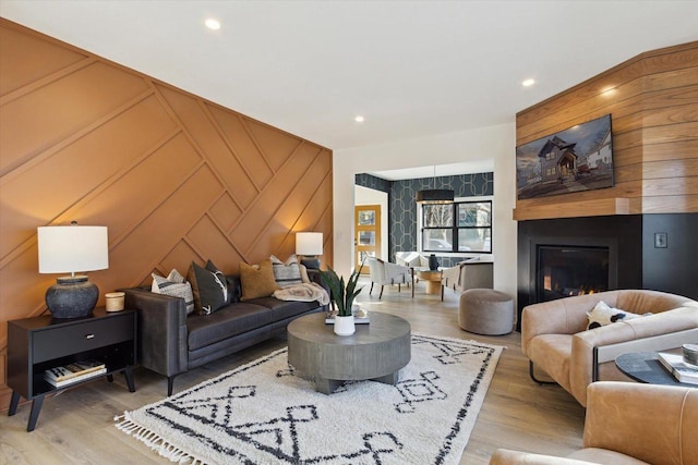 living room with a fireplace and light hardwood / wood-style flooring