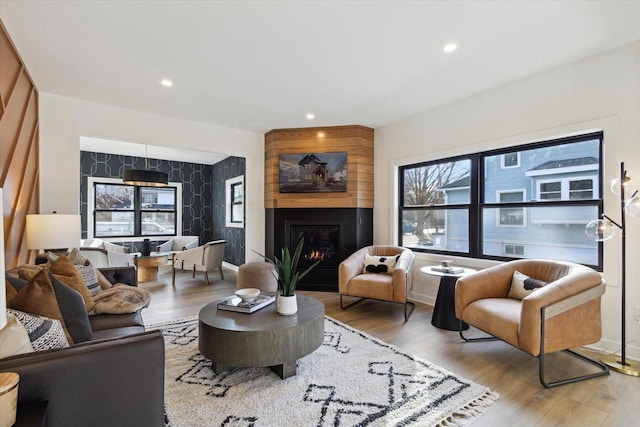 living room featuring a large fireplace and light wood-type flooring