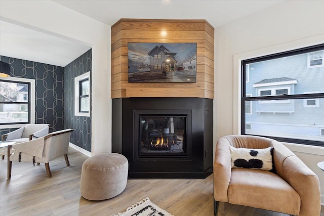 sitting room featuring a fireplace and wood-type flooring