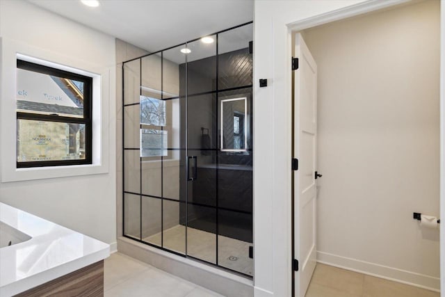 bathroom with tile patterned flooring and walk in shower