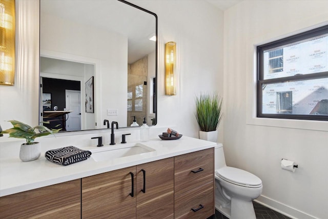 bathroom with vanity, a shower, and toilet