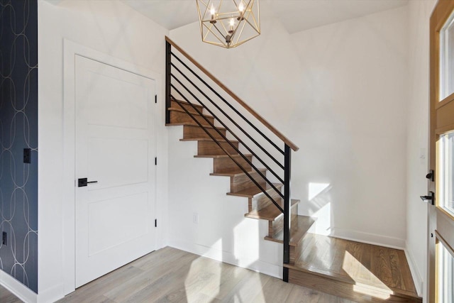 entryway featuring a chandelier and light hardwood / wood-style flooring