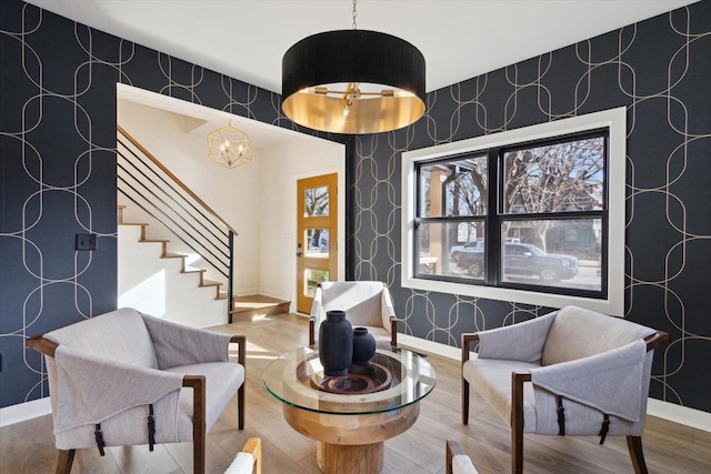 sitting room featuring hardwood / wood-style floors and a chandelier