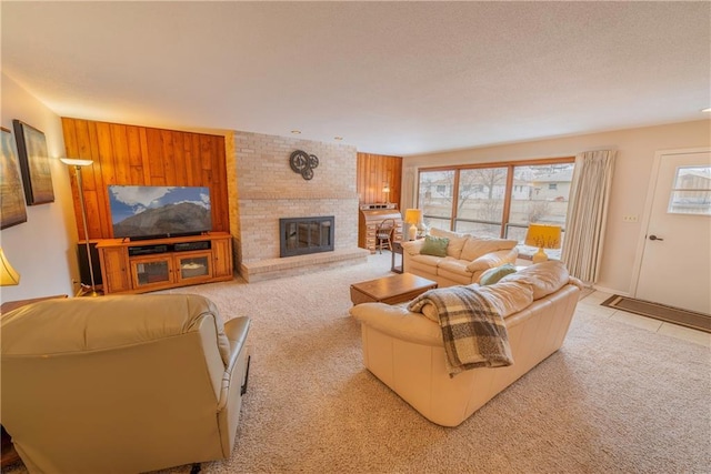 carpeted living room with wooden walls, a wealth of natural light, and a fireplace