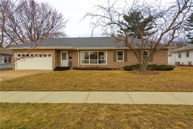 single story home with a garage, a front yard, and central air condition unit