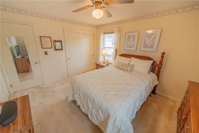 carpeted bedroom with ceiling fan and a closet