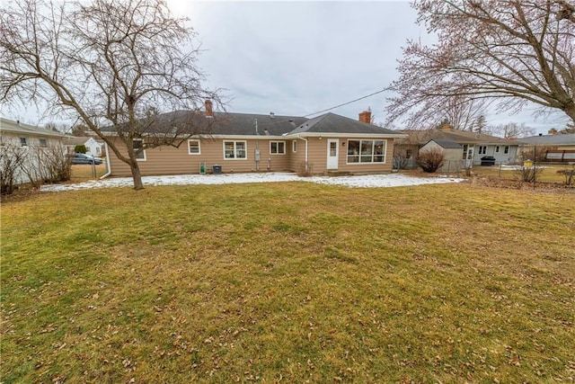 rear view of house with a patio and a yard