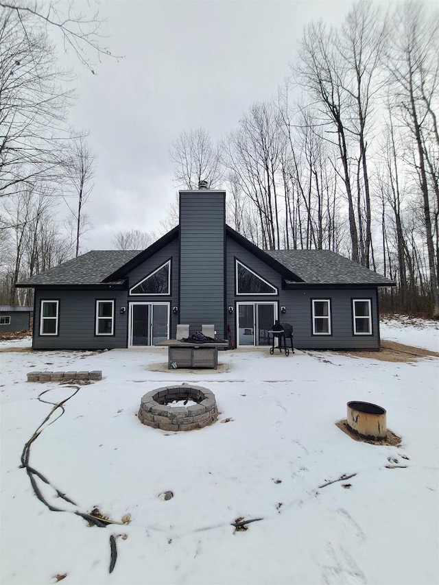 snow covered property featuring a fire pit