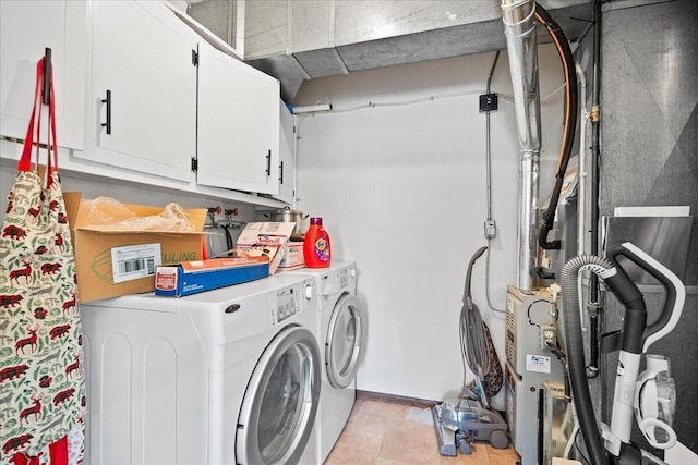 washroom featuring cabinets and washing machine and clothes dryer