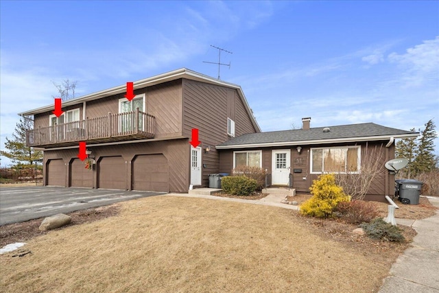 view of front of house featuring a garage and a balcony