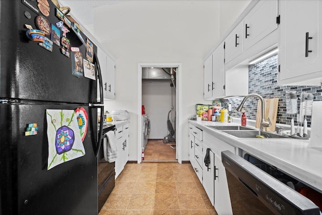 kitchen featuring black refrigerator, sink, dishwasher, and white cabinets