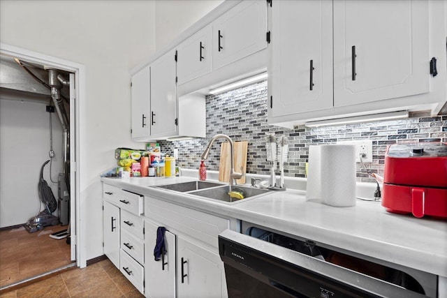 kitchen featuring tasteful backsplash, dishwasher, sink, and white cabinets