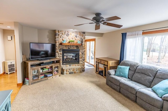 living room featuring a fireplace and ceiling fan