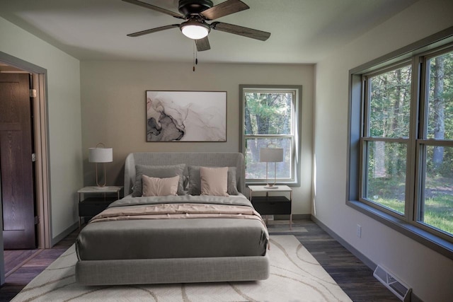 bedroom with dark wood-type flooring and ceiling fan