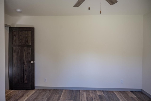 unfurnished room featuring ceiling fan and dark hardwood / wood-style flooring