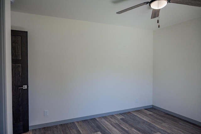 spare room with ceiling fan and dark hardwood / wood-style floors