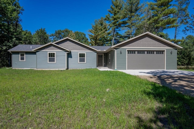 ranch-style house with a garage and a front lawn