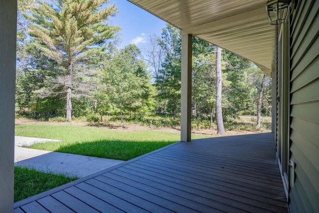 wooden terrace featuring a lawn