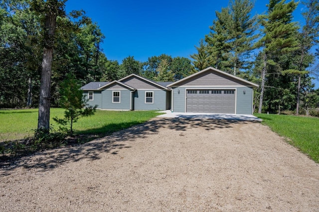 single story home featuring a garage and a front lawn