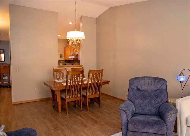 dining area featuring hardwood / wood-style flooring and lofted ceiling