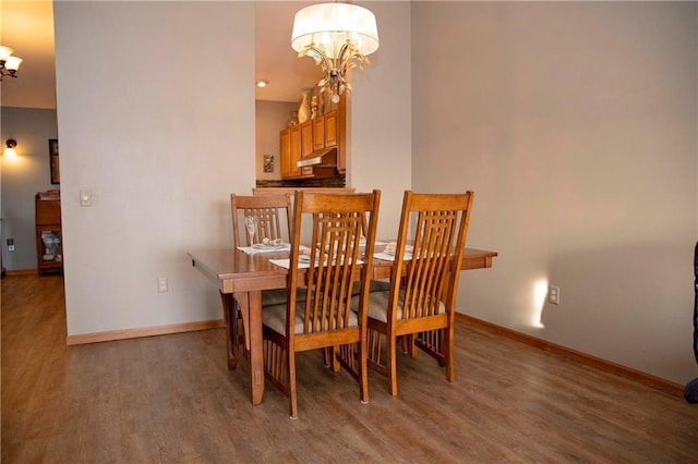 dining space with an inviting chandelier and hardwood / wood-style flooring