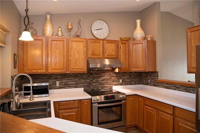 kitchen with pendant lighting, sink, stainless steel range with electric stovetop, tasteful backsplash, and ventilation hood