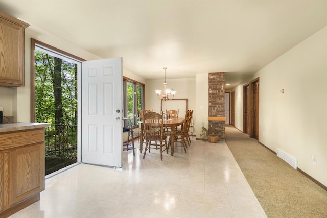 dining room featuring a notable chandelier and light tile patterned floors