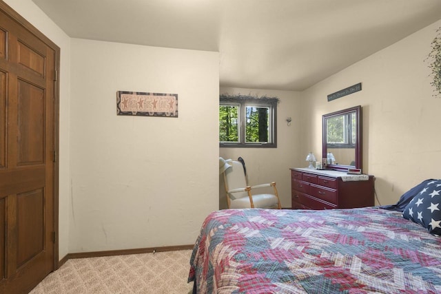 bedroom featuring light carpet