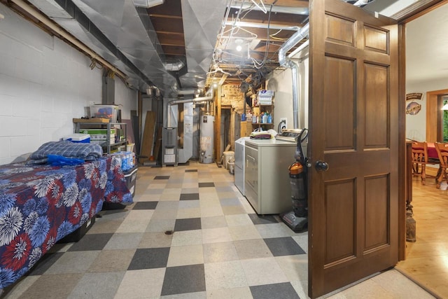 basement featuring water heater and washer and dryer