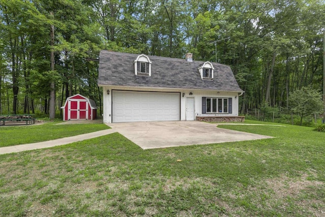 cape cod home featuring a storage shed, a garage, and a front yard