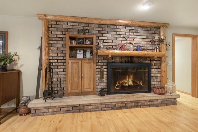 details featuring a brick fireplace and hardwood / wood-style floors