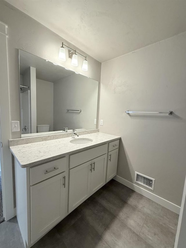 bathroom featuring vanity and toilet