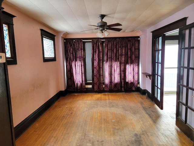 unfurnished room featuring ceiling fan, a healthy amount of sunlight, and light hardwood / wood-style floors