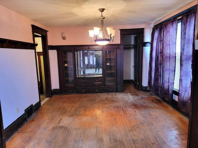 interior space featuring an inviting chandelier and hardwood / wood-style floors